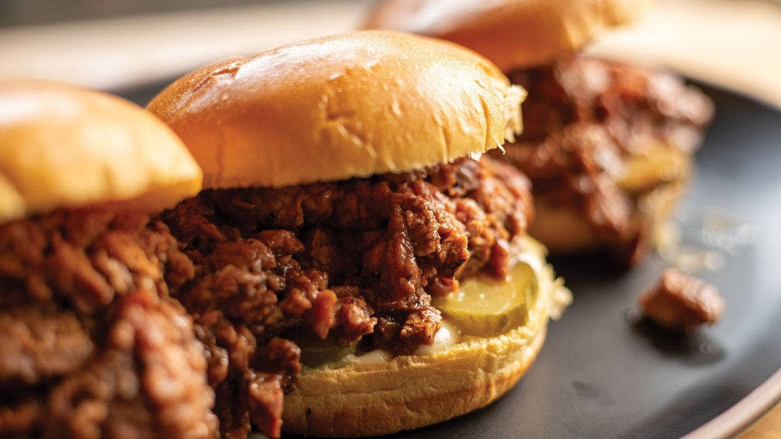 Cooked BBQ TriTip sandwiches with pickles on a plate